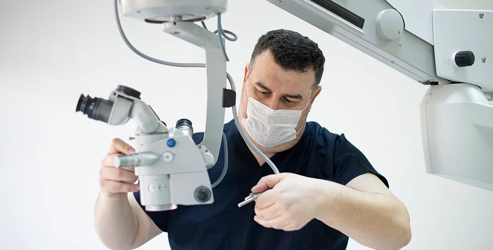 Biomedical equipment technician working on medical device repair in healthcare facility